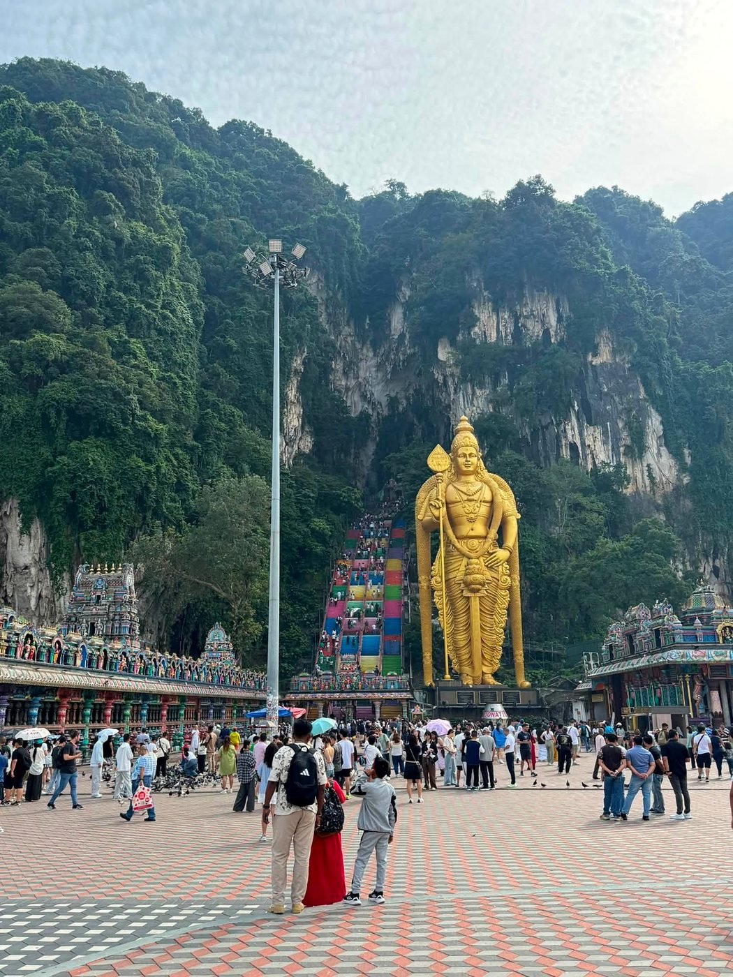 Estátua dourada de Murugan e escadaria colorida das Batu Caves