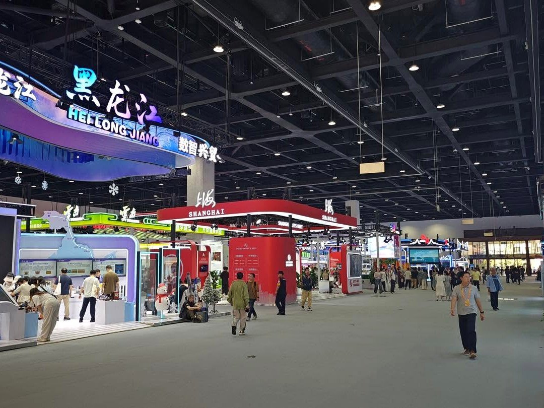 Vista interna de um pavilhão de feira em Pequim, com estandes de várias províncias chinesas