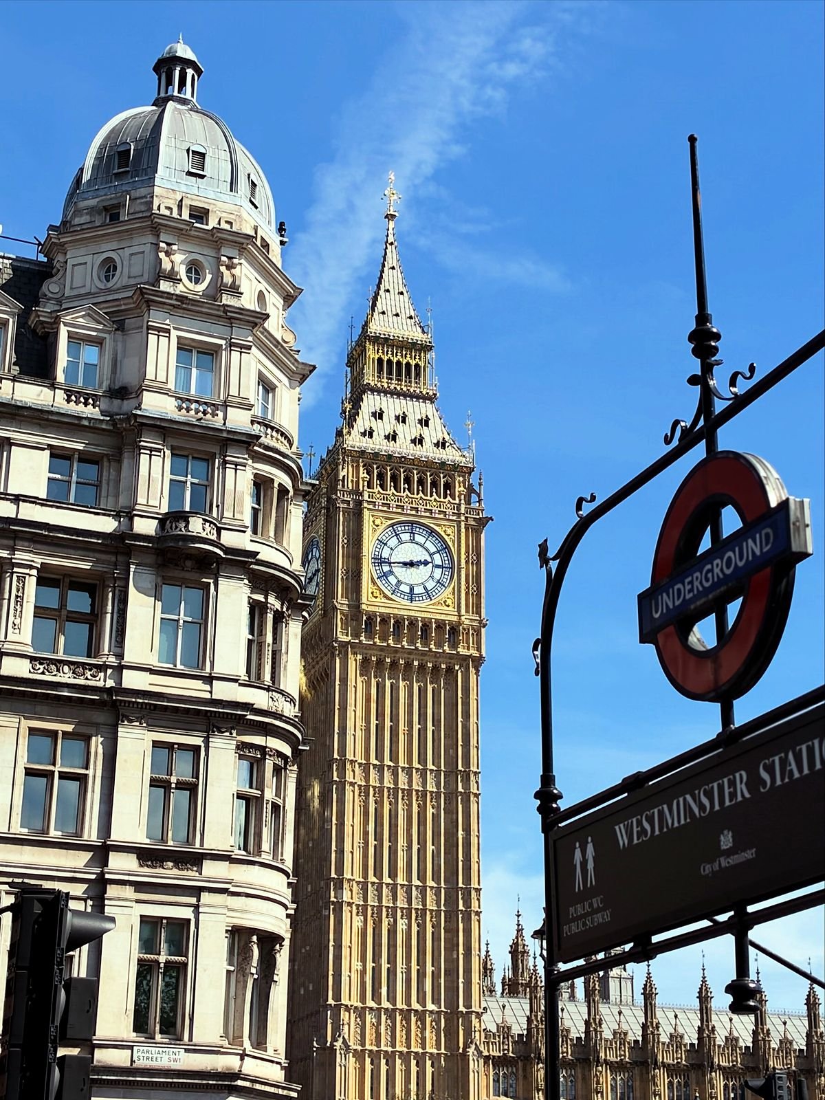 Big Ben e a placa da estação Westminster do metrô em dia de céu azul