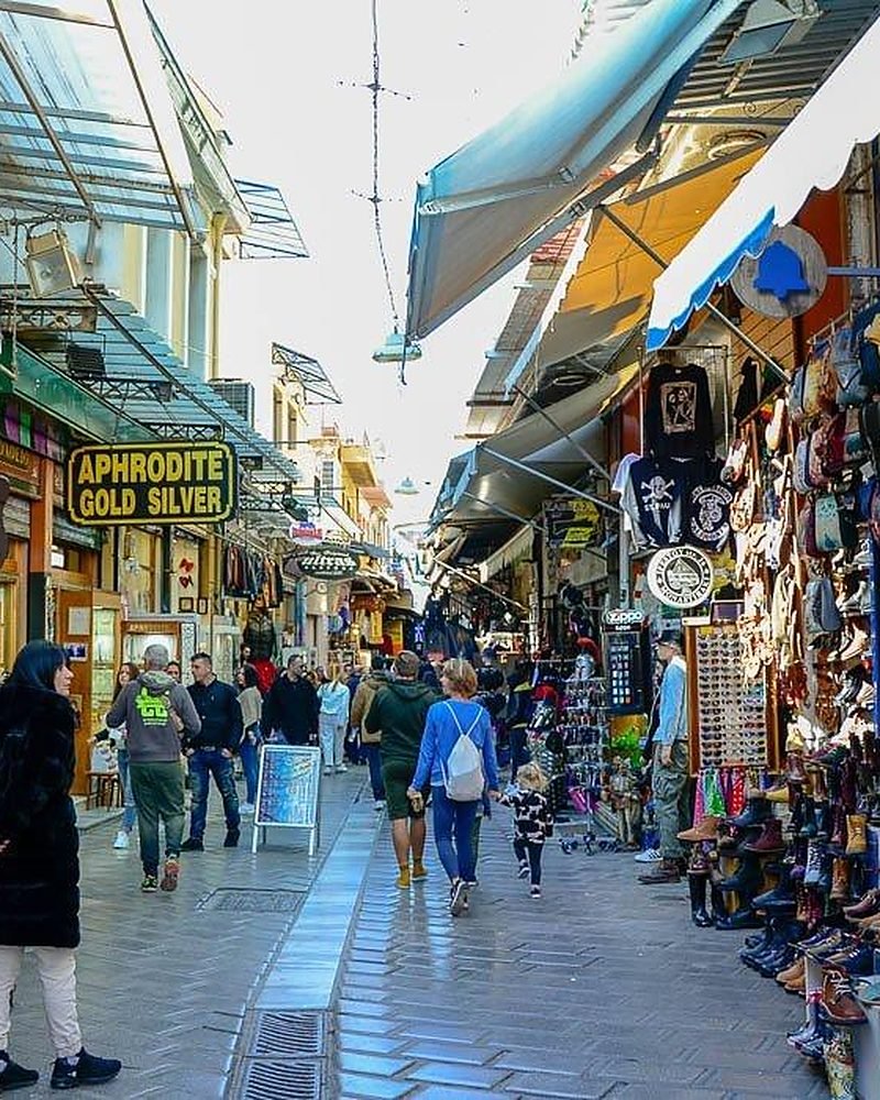 Rua de lojas e turistas no mercado de Monastiraki, em Atenas