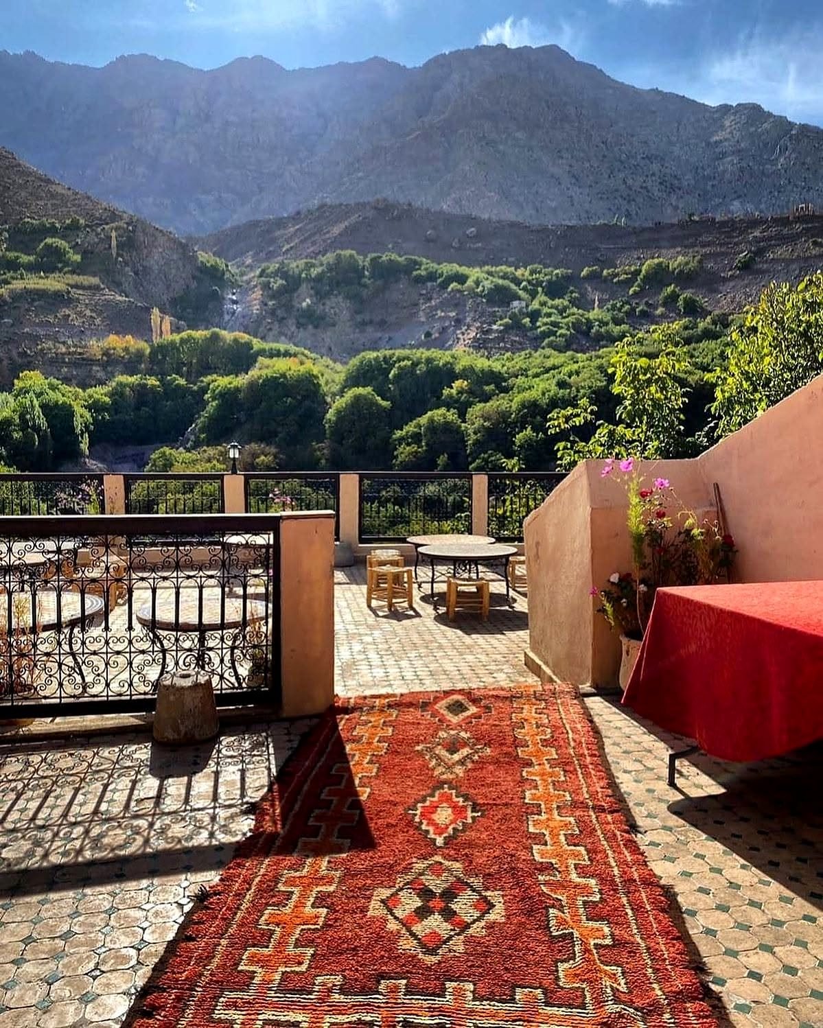 Terraço com tapete berbere e vista do vale verde nas Montanhas do Atlas
