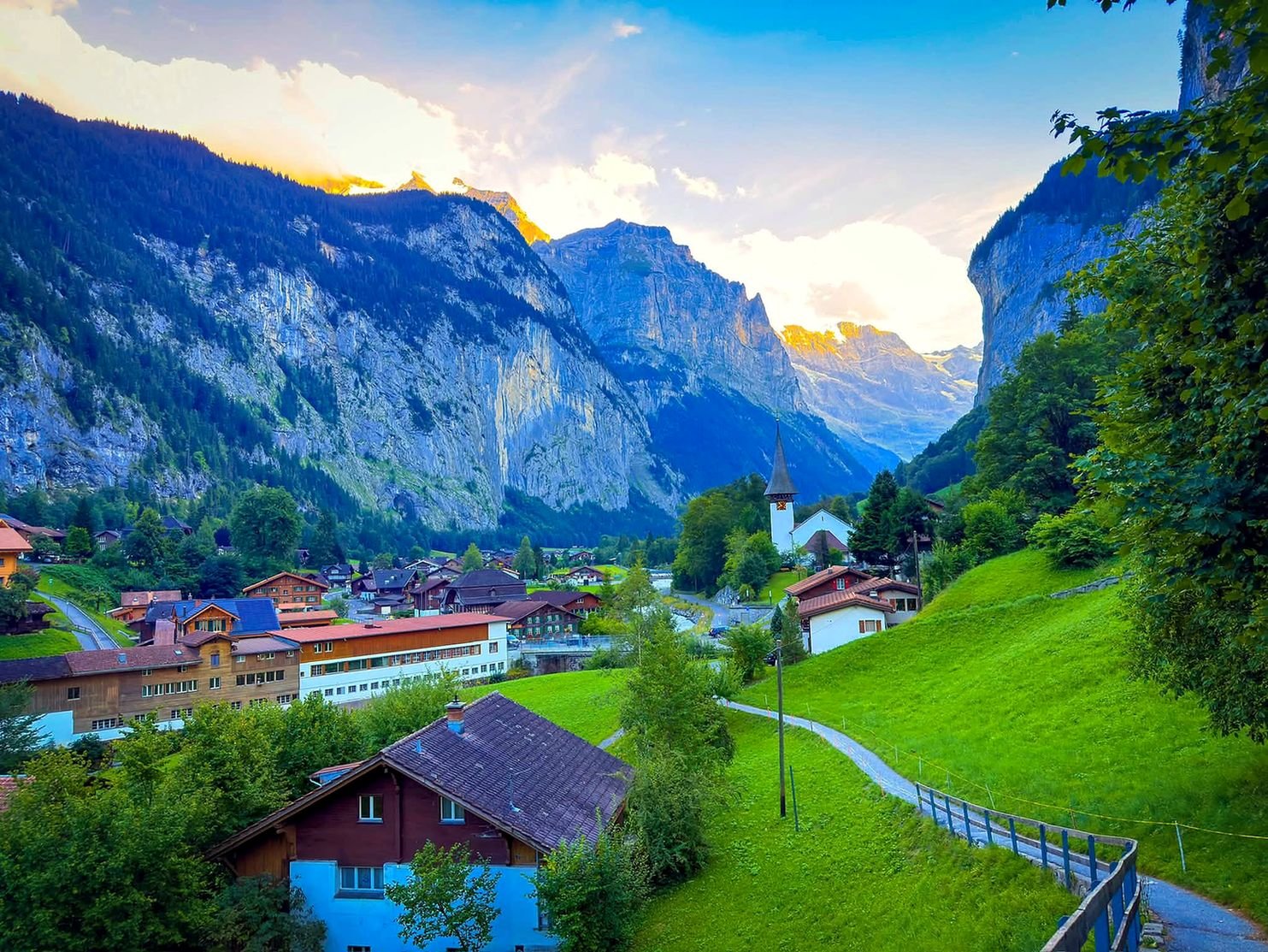Pôr do sol no vale de Lauterbrunnen com paredões de pedra e chalés