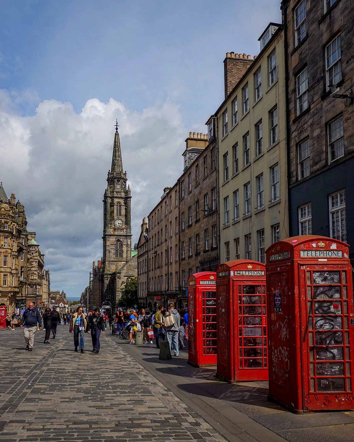 Royal Mile em Edimburgo com cabines telefônicas vermelhas e a torre do Tron Kirk