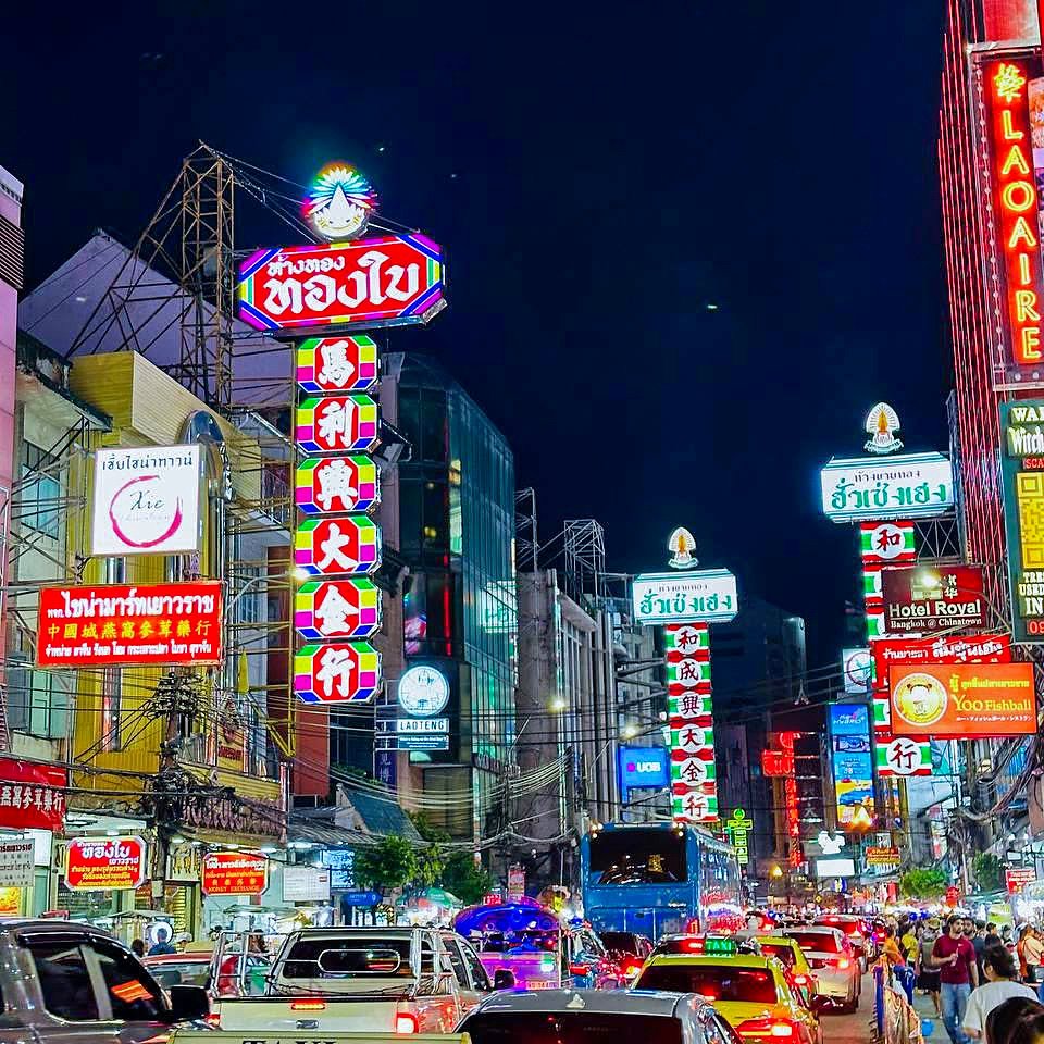 Rua Yaowarat, a Chinatown de Bangkok, à noite com letreiros de neon