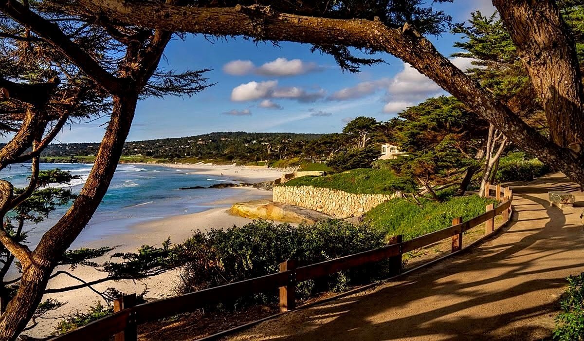 Praia de Carmel-by-the-Sea vista do passeio entre ciprestes