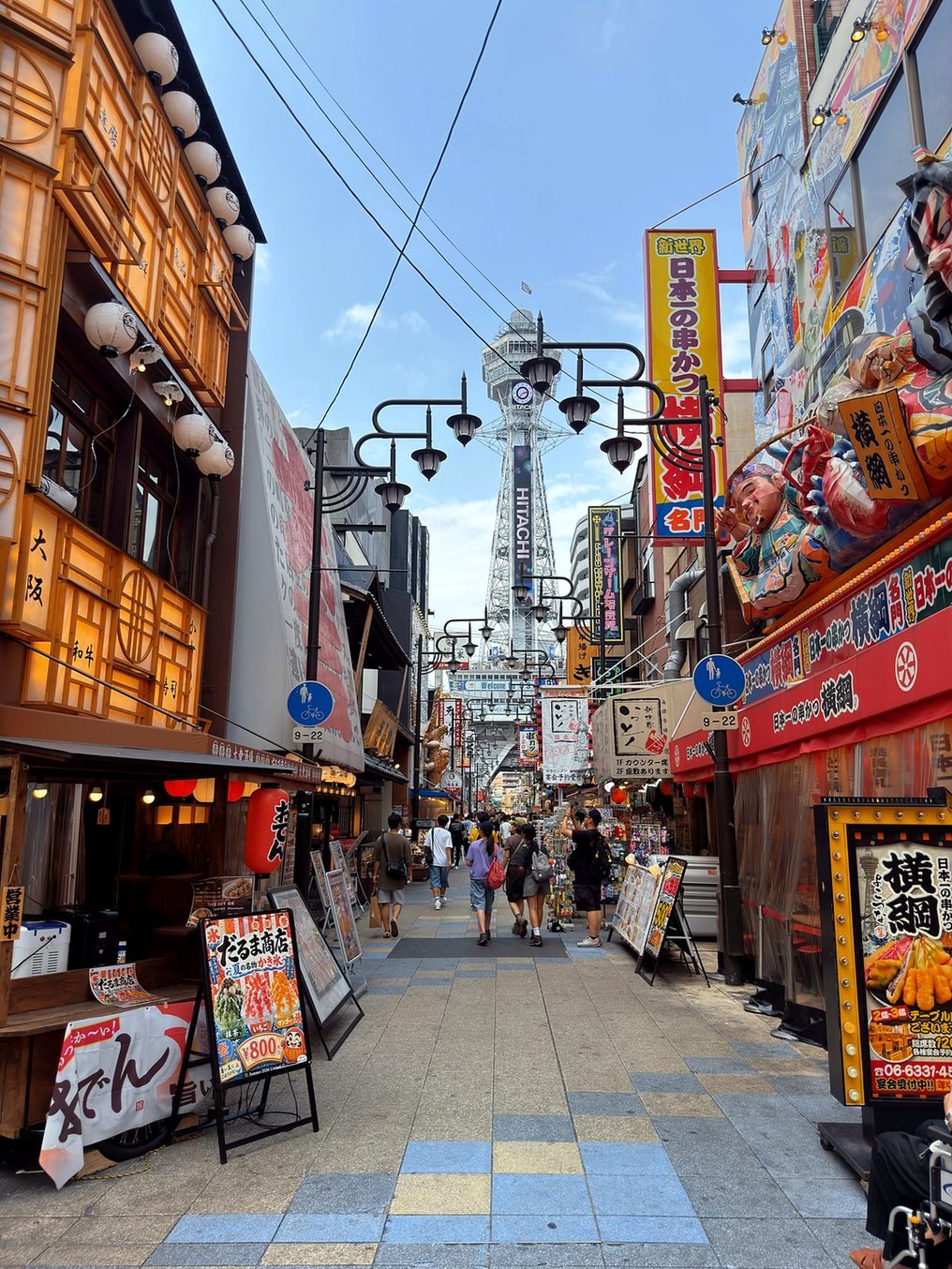 Rua do bairro Shinsekai com a Torre Tsutenkaku ao fundo, em Osaka