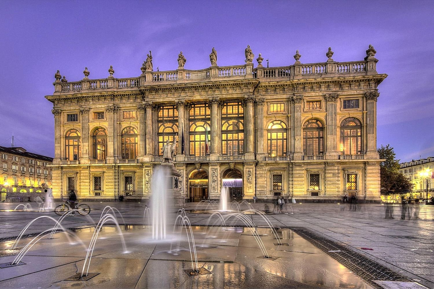 Palazzo Madama iluminado &agrave; noite com as fontes da Piazza Castello, em Turim