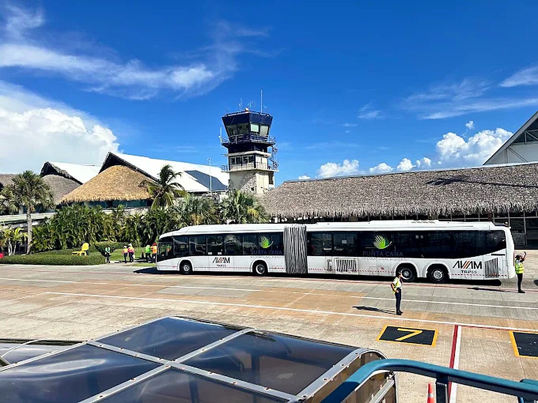 Aeroporto Internacional de Punta Cana com torre de controle e terminais de teto de palha